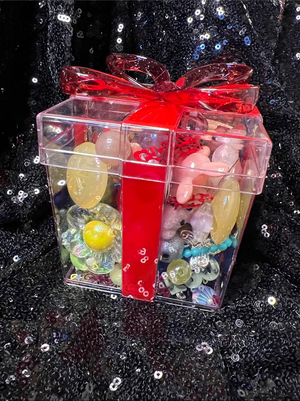 Christmas box filled with assorted beads buttons, and charms